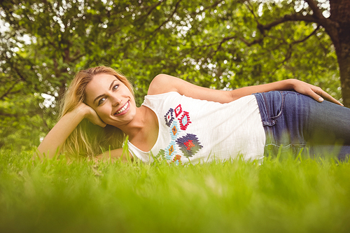 Cheerful woman relaxing on grass