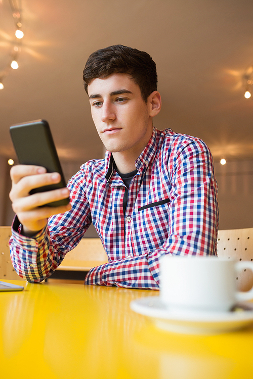 Low angle view of young man using mobile phone