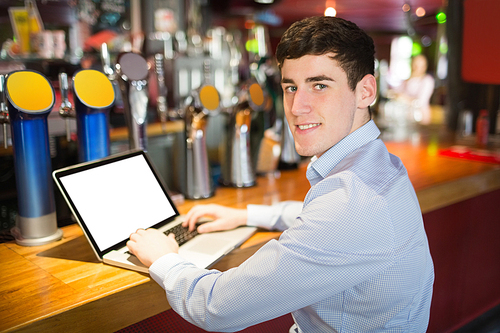Portrait of happy man using laptop