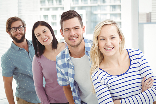 Portrait of smiling business professionals standing in row