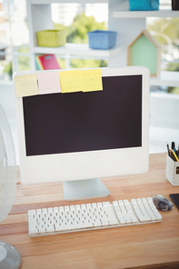 Sticky notes on computer monitor at desk