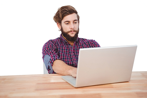 Hipster working on laptop at desk