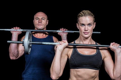 Portrait of muscular man and woman lifting crossfit