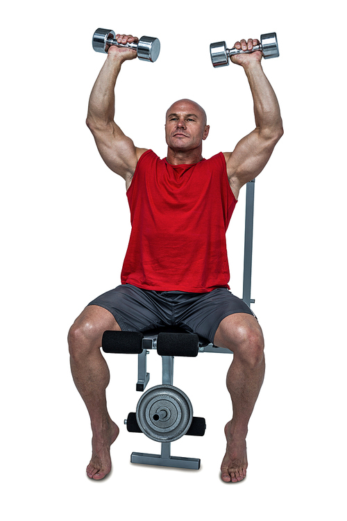 Muscular man exercising while sitting on bench press