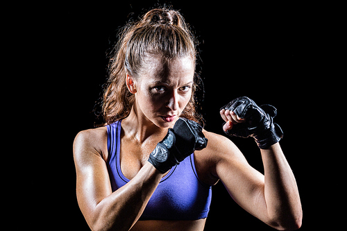 Portrait of female confident boxer with fighting stance