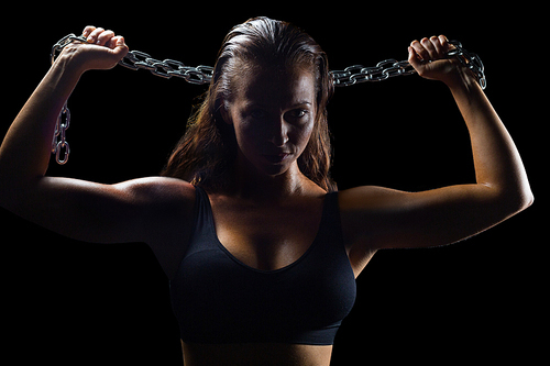 Portrait of athlete in sportswear holding chain