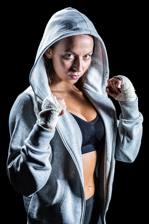 Portrait of female boxer in hood with fighting stance