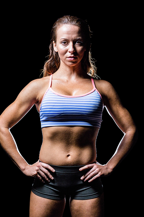 Portrait of female athlete with hands on hip
