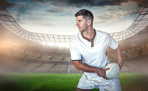 Composite image of rugby player holding the ball aside