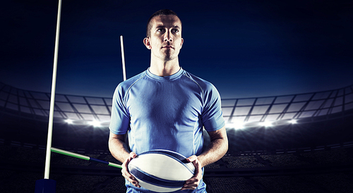 Composite image of confident rugby player holding ball