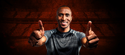 Composite image of portrait of confident athlete smiling and showing thumbs up