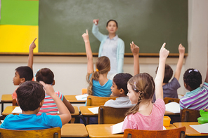 Teacher asking a question to her class at the elementary school