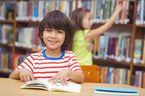 Pupil smiling at camera in library at the elementary school