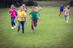 Cute pupils running towards camera on elementary school campus