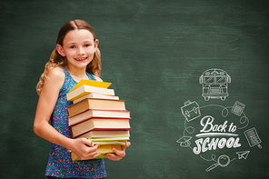 Cute little girl carrying books in library against green chalkboard