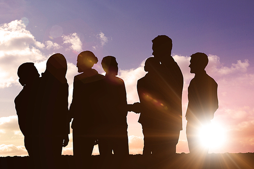 Silhouetters celebrating against sun shining