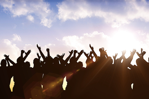 Silhouetters celebrating against sun shining