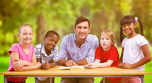 Teacher and pupils smiling at camera at library  against trees and meadow