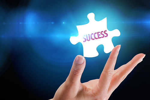 The word success  and hand showing against blue background with vignette