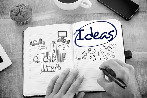 The word ideas  and man writing notes on diary against business and cityscape