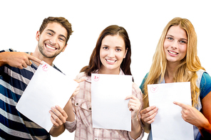 Smiling students showing their exams against white background with vignette