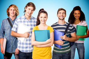 Students holding folders in college against blue background with vignette