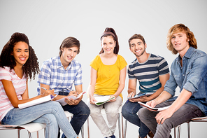 College students doing homework against grey vignette