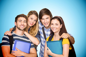 Students holding folders at college corridor against blue background with vignette