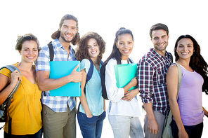 Smiling group of students standing in a row against white background with vignette