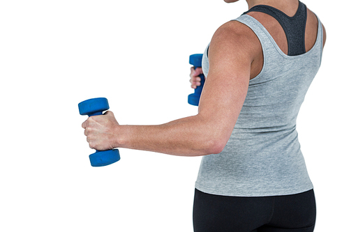 Muscular woman working out with dumbbells on white background