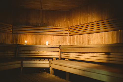A sauna room with lit candles  at the spa