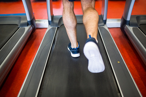 Man running on a treadmill at the gym