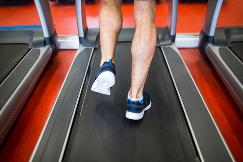 Man running on a treadmill at the gym