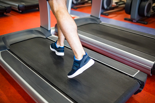 Man running on a treadmill at the gym