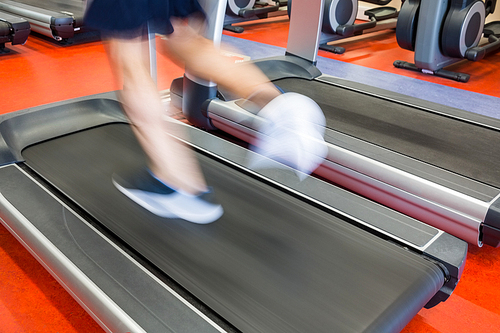 Man running on a treadmill at the gym