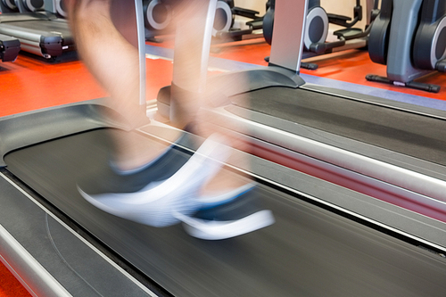 Man running on a treadmill at the gym