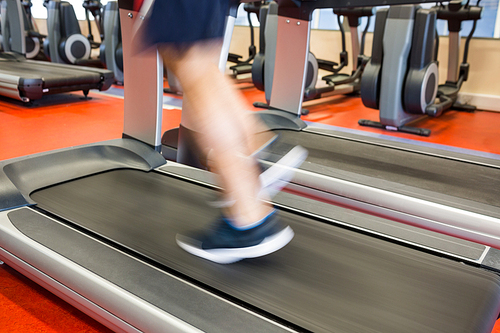 Man running on a treadmill at the gym