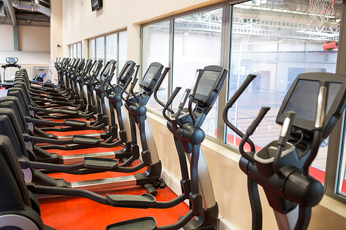 Collection of cross trainer machines in a row at the gym