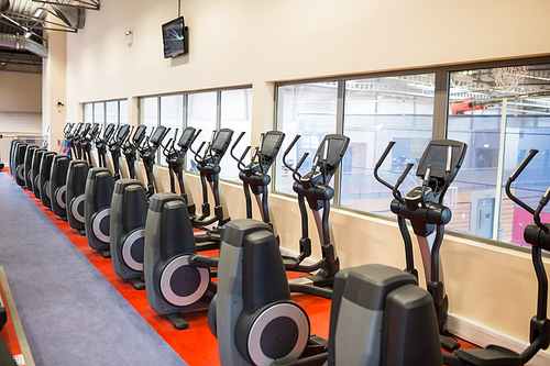 Collection of cross trainer machines in a row at the gym