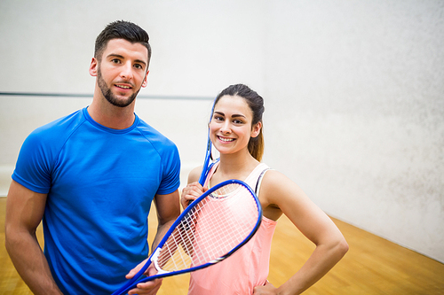 Couple play some squash together in the squash court