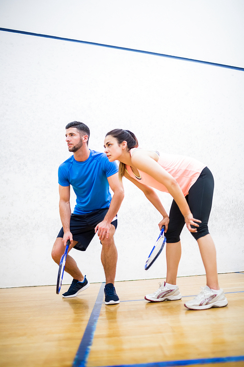 Couple tired after a squash game in the squash court