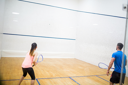 Couple enjoying a game of squash in the squash court