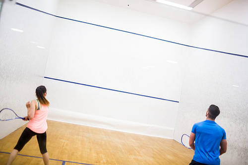 Couple enjoying a game of squash in the squash court