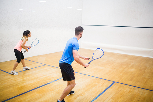 Couple enjoying a game of squash in the squash court