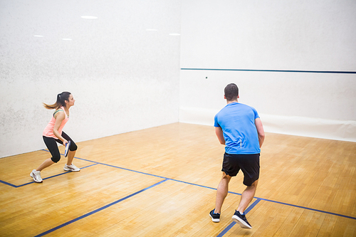 Couple enjoying a game of squash in the squash court