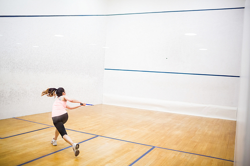 Woman playing a game of squash in the squash court