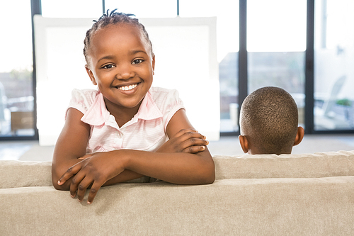 Two children sitting on sofa in living room