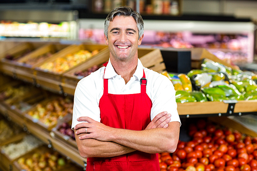 Portrait of smiling man wearing apron at supermarket