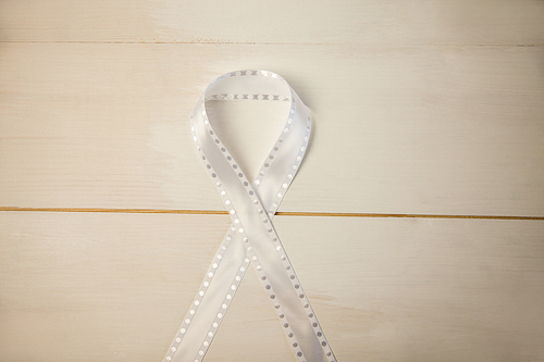 White ribbon on wooden desk shot in studio