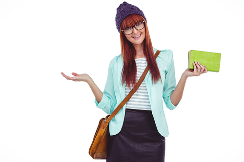 Smiling hipster woman with bag and book against white background